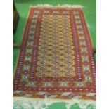 A beige ground Bokhara rug with red and blue geometric borders