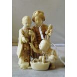 A 19th Century ivory okimono mother and children, signed (a/f)