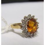 A 14k orange stone and diamond cluster ring
