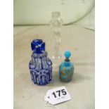 A blue glass overlay scent bottle with stopper and small blue glass scent bottle with naked lady