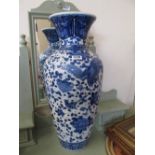 A tall modern blue and white vase