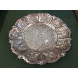 An Islamic white metal bowl embossed stylized flowers on paw feet