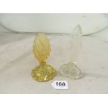 A glass scent bottle with tall stopper and yellow scent bottle the stopper etched nude diver