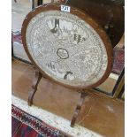 An oak tip up occasional table with floral and bird insert