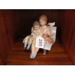 A Lladro group boy and girl on bench with puppy