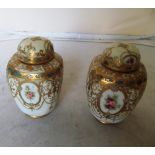 A pair of Noritake vases decorated reserves of roses within gilt embellishments (both lids