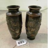 A pair of oriental bronze vases mixed metal relief design