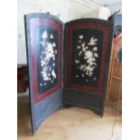 An early 20th Century Japanese two fold screen with carved surround, lacquer panels with carved
