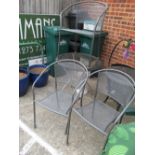 A glass topped and wicker effect circular garden table and three chairs