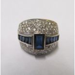 An 18ct gold diamond and sapphire ring, size K/L