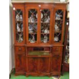 A small reproduction breakfront bookcase