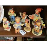 Five Hummel figures (two chipped bases) and two Hummel style figures