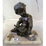 A bronze cherub seated with musical instrument on marble base