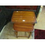 A nest of three occasional tables with brass corners.