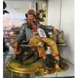 A Capodimonte figure on bench