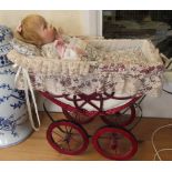 A doll's pram and doll