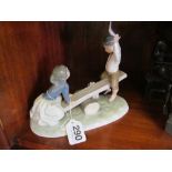 Lladro figure boy and girl on see-saw