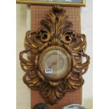 A gilt barometer scroll frame