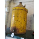 A vintage yellow painted metal oil or diesel dispensing can with brass tap