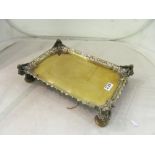 A brass and bronze rectangular tray with pierced edge and winged caryatid corners