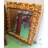 A decorative gilt wood mirror scroll decoration