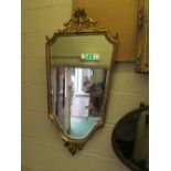 A gilt shield shape mirror
