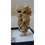 A 19th Century ivory okimono monkey carrying a basket of frogs, signed