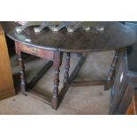 An 18th Century oak gateleg table on turned legs with drawer