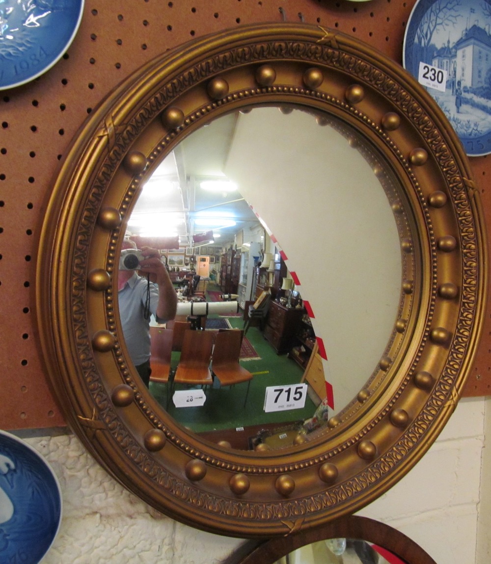 A gilt convex circular mirror