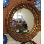 A gilt convex circular mirror