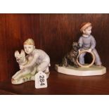 Two Russian figures boy with hoop and dog and another boy crouching with dog