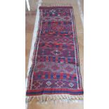 A Turkish rug banded design and plaited tassels