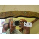 An oval mirror in painted frame