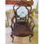 An oriental chair with marble back and a two tier table