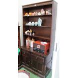 An Ercol open bookcase two cupboards under