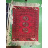 A small red ground Bokhara rug