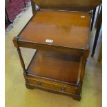 A pair of reproduction mahogany two tier side tables with drawers to base