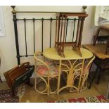 A folding magasine rack, nest of three tables, an iron headboard and a bamboo/cane table and chairs