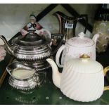 A silver lustre teapot on stand and two jugs and three other teapots