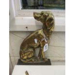 A brass dog doorstop