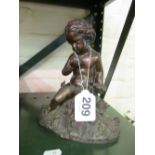 A bronze figure seated cherub with dove