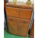 A 1960s retro cocktail cabinet with rising top and cupboards below