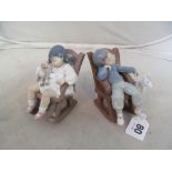 A Lladro figure girl asleep in rocking chair with doll and another boy asleep in rocking chair