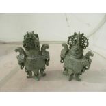 A pair of carved Chinese green stone urns and covers and celadon incense burner