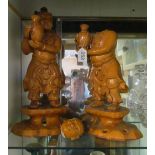 A pair of glazed pottery oriental figures men holding vases (one a/f)