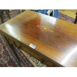 A late Victorian rosewood games/work table with a foldover top revealing backgammon, chess and