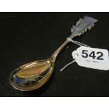 A Swedish Sami style white metal spoon decorated with incised reindeer and figure