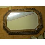 An octagonal mirror with pokerwork frame