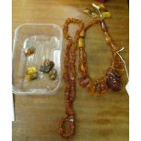 An amber necklace strung with irregular shaped pieces and a smaller bead necklace