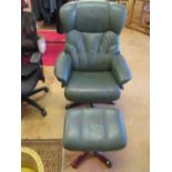 A green leather recliner chair and stool